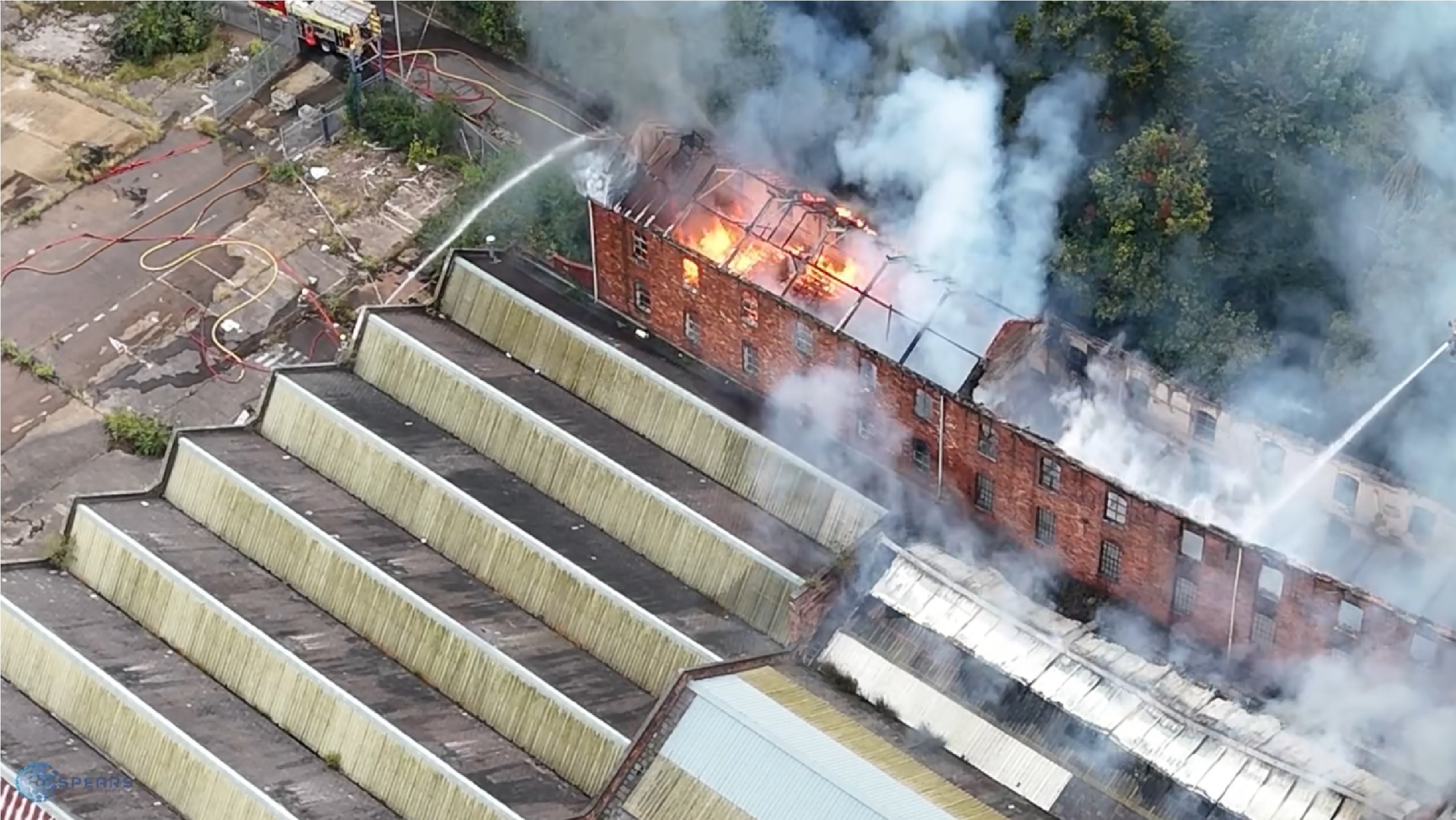 birminghamworld.uk - Jessica Martin - Drone footage shows flames and smoke pouring from roof of massive factory building